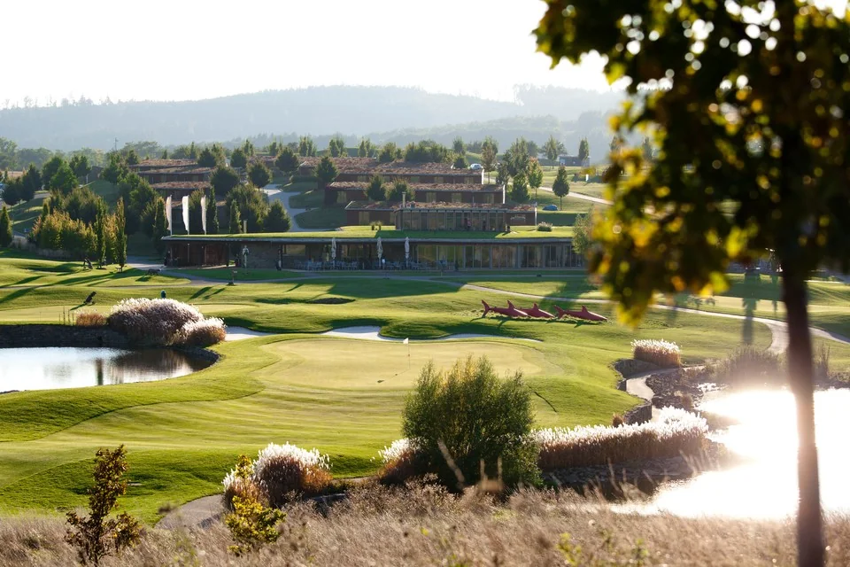 Kaskádas golfbana med vattenhinder och resortboende i bakgrunden